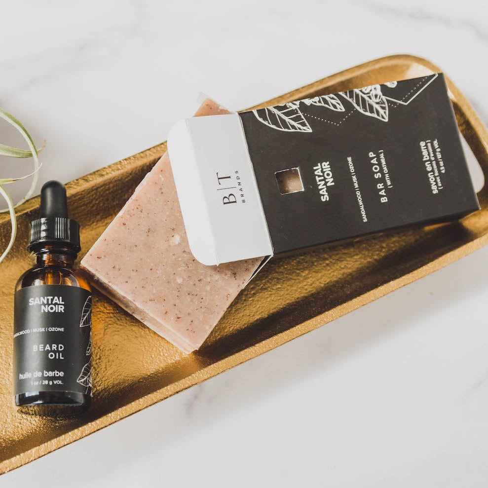Santal Noir bar soap on metal dish with beard oil