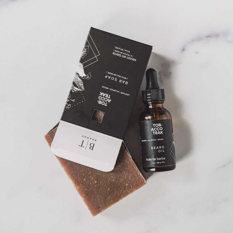 Sitka Woodland bar soap on white table and beard oil