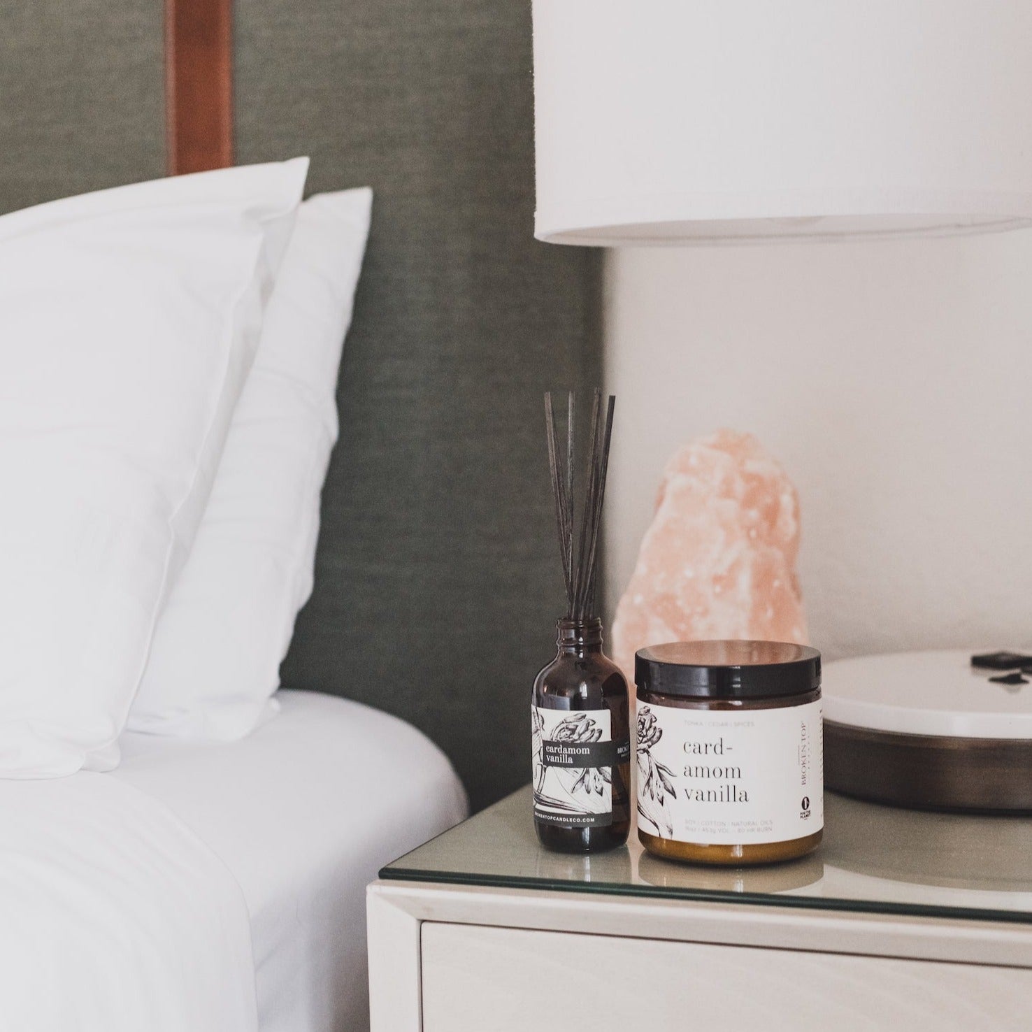 16oz Cardamom Vanilla candle on side table next to reed diffuser