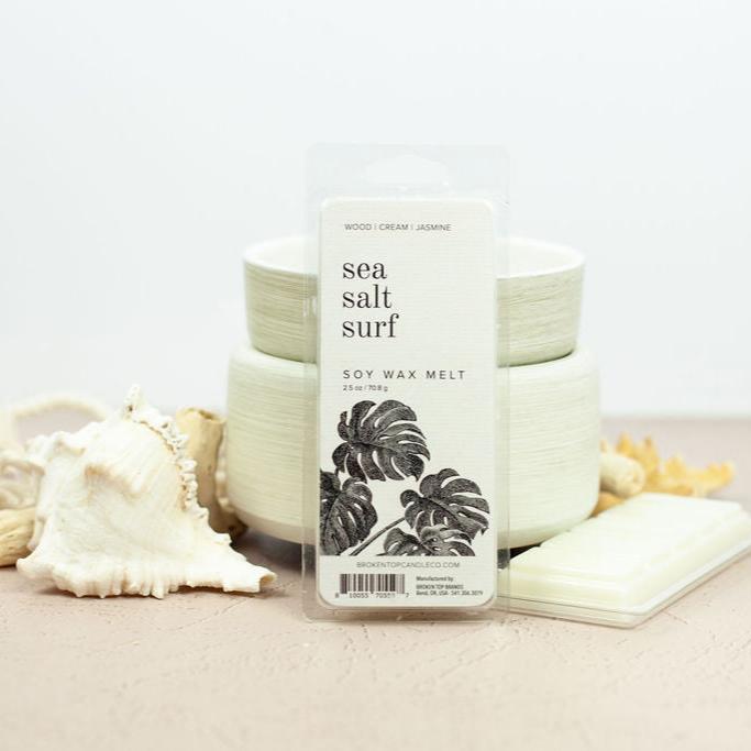 Sea Salt Surf Wax Melts infront of white wax warmer next to ocean items.