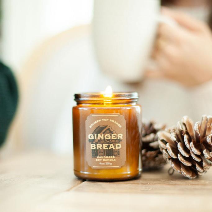 9oz Ginger Bread candle on counter next to pinecones