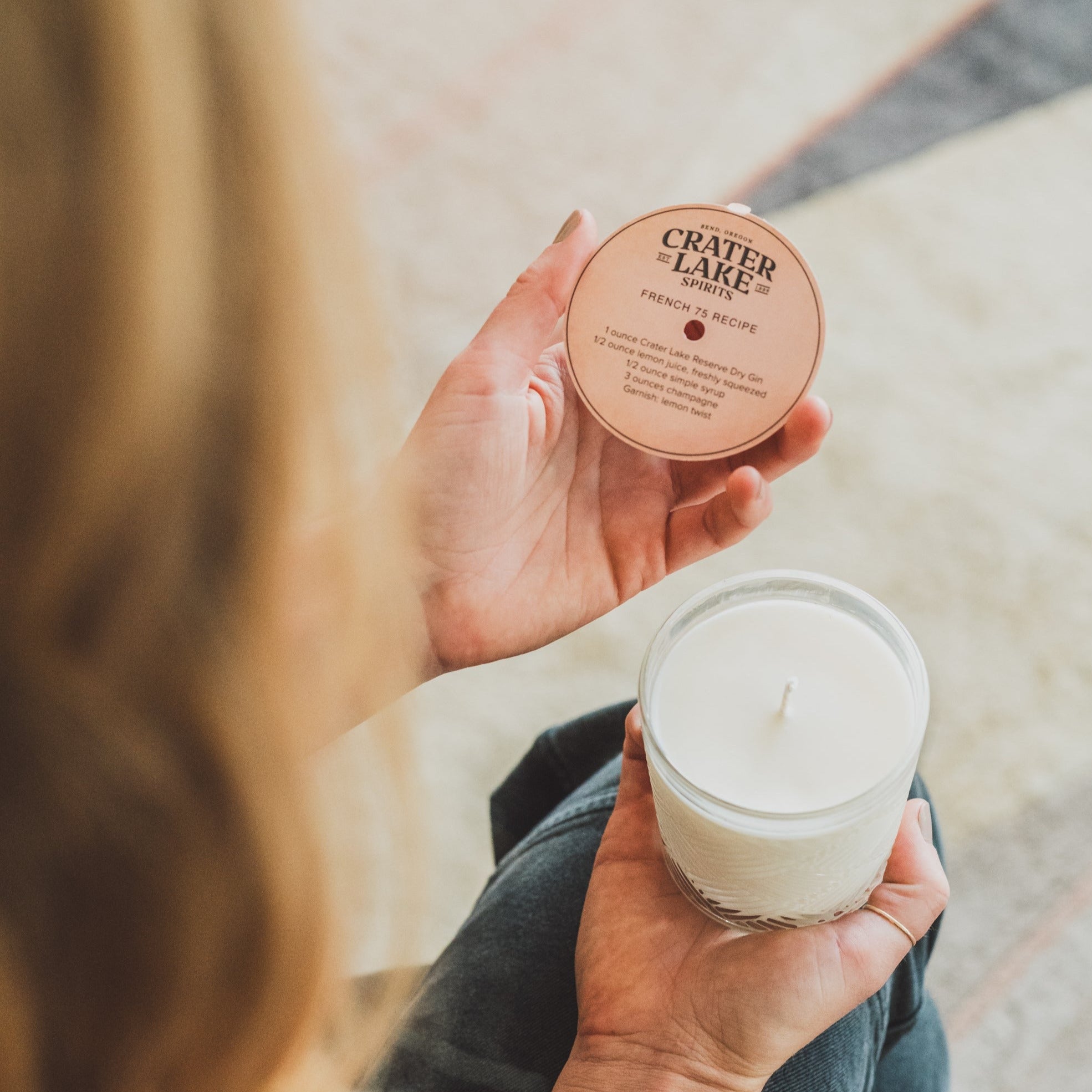 French 75 11oz candle being held by women