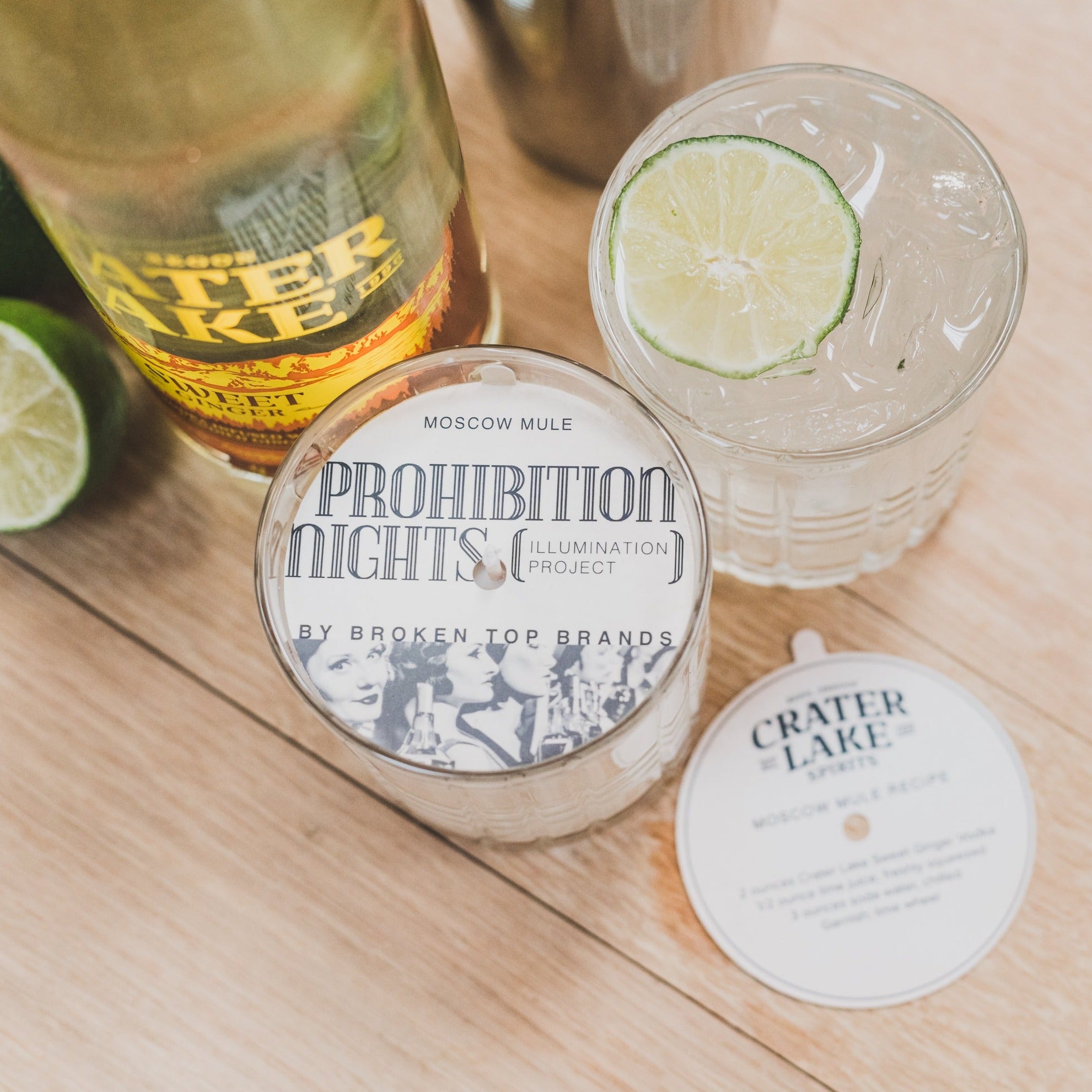 Moscow Mule 11oz candle on table next to drinks