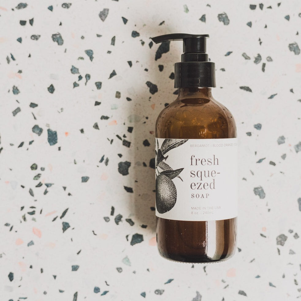 Fresh Squeezed 8oz liquid soap on black and white speckled table