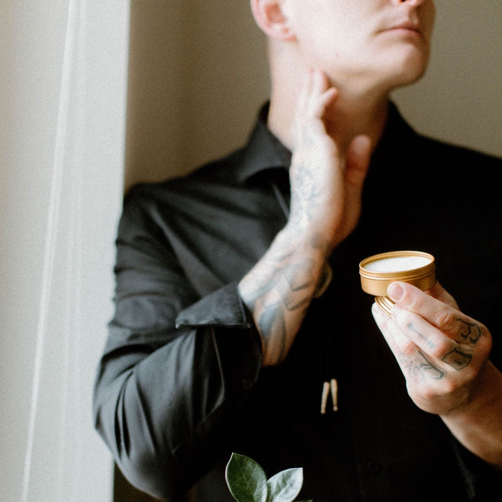 Sitka Woodland solid cologne being held by gentleman