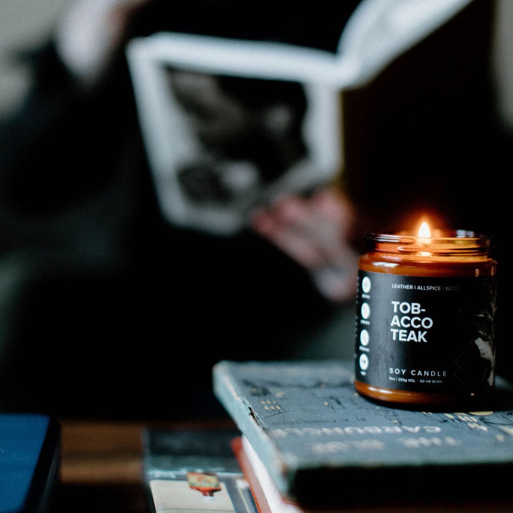 9oz Tobacco Teak candle on books