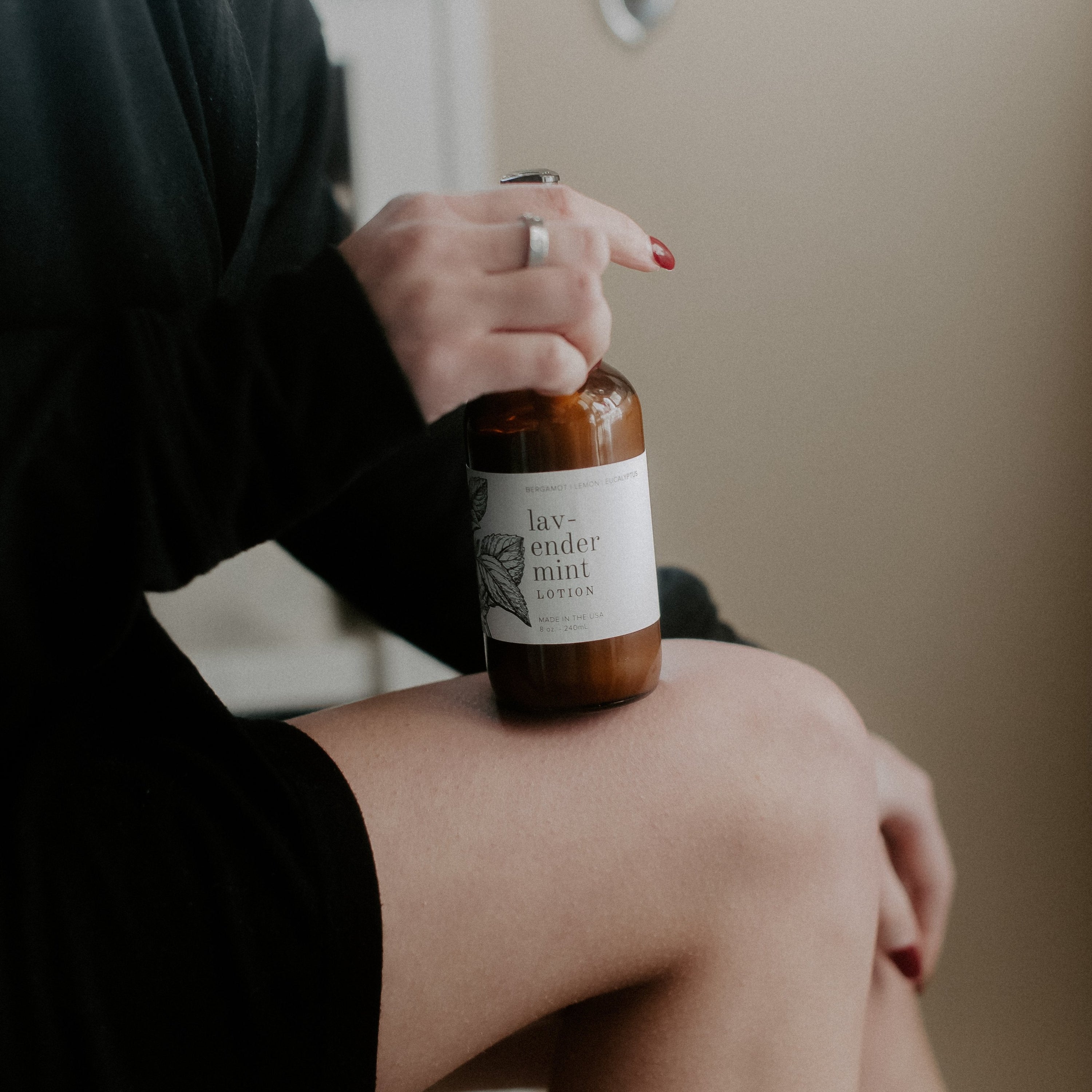 Lavender Mint 8oz lotion on women's leg and being held by women