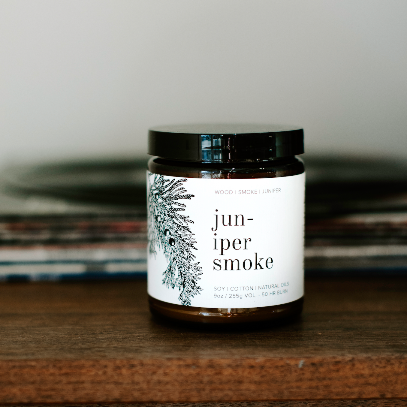 9oz Juniper Smoke candle on wooden table