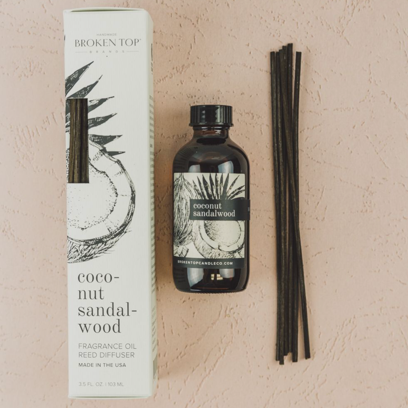 Coconut Sandalwood Reed diffuser and box on pink background