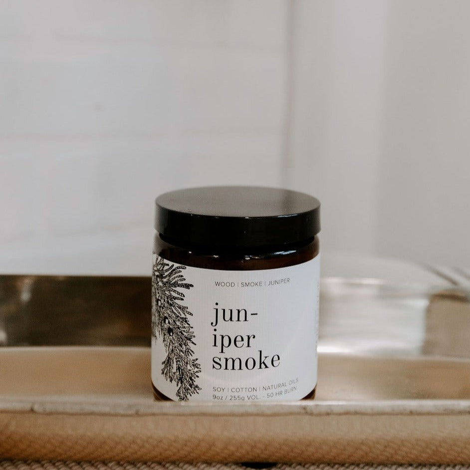 9oz Juniper Smoke candle on table