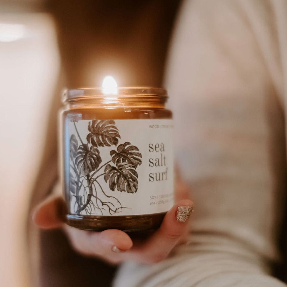 9oz Sea Salt Surf Soy Candle held in women's hand