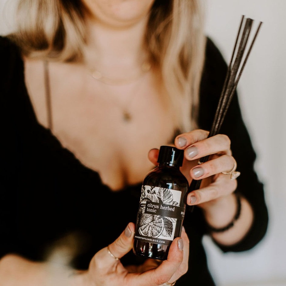 Citrus Herbed Tonic Reed diffuser held in women's hands