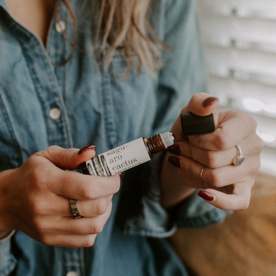 Saguaro Cactus roll-on perfume being held by women's hands