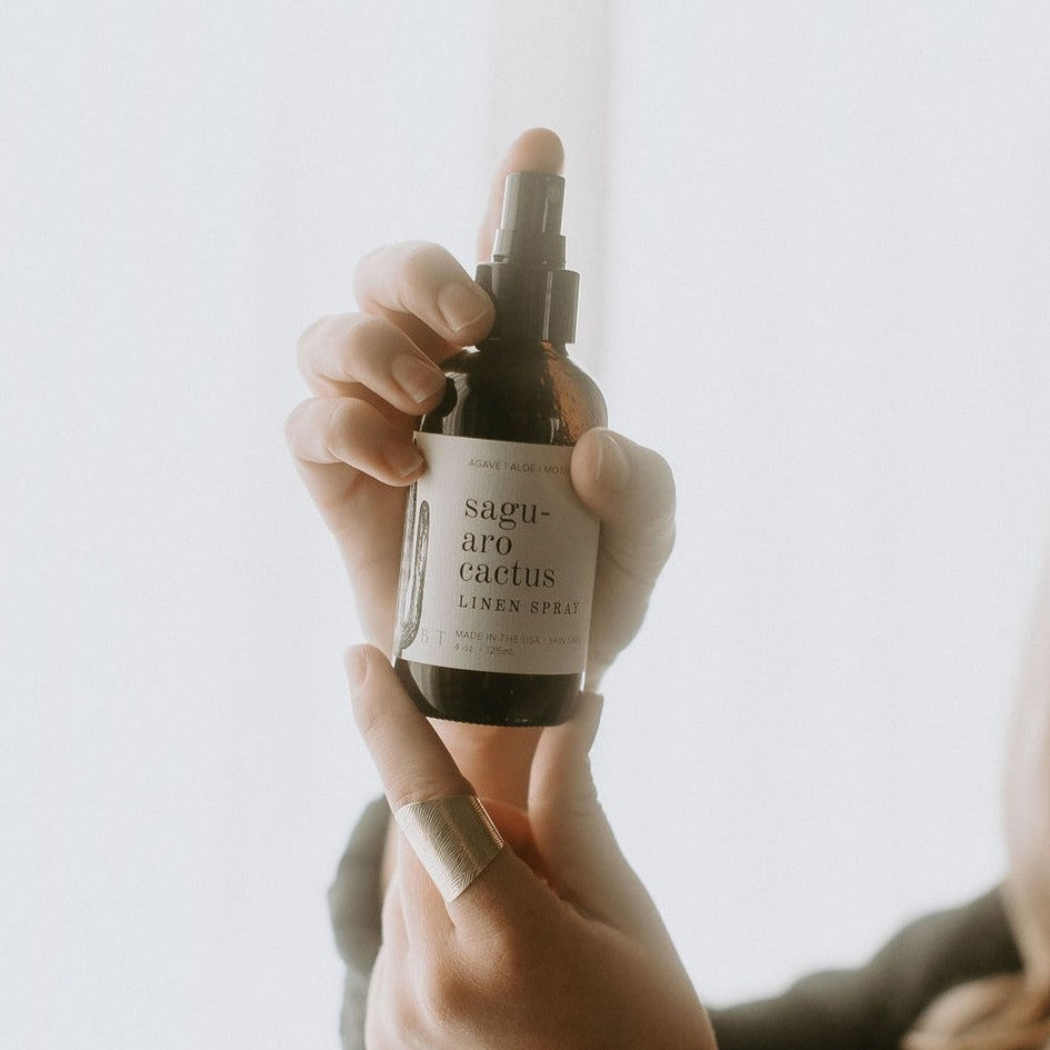 4oz Saguaro Cactus linen spray held by women's hands