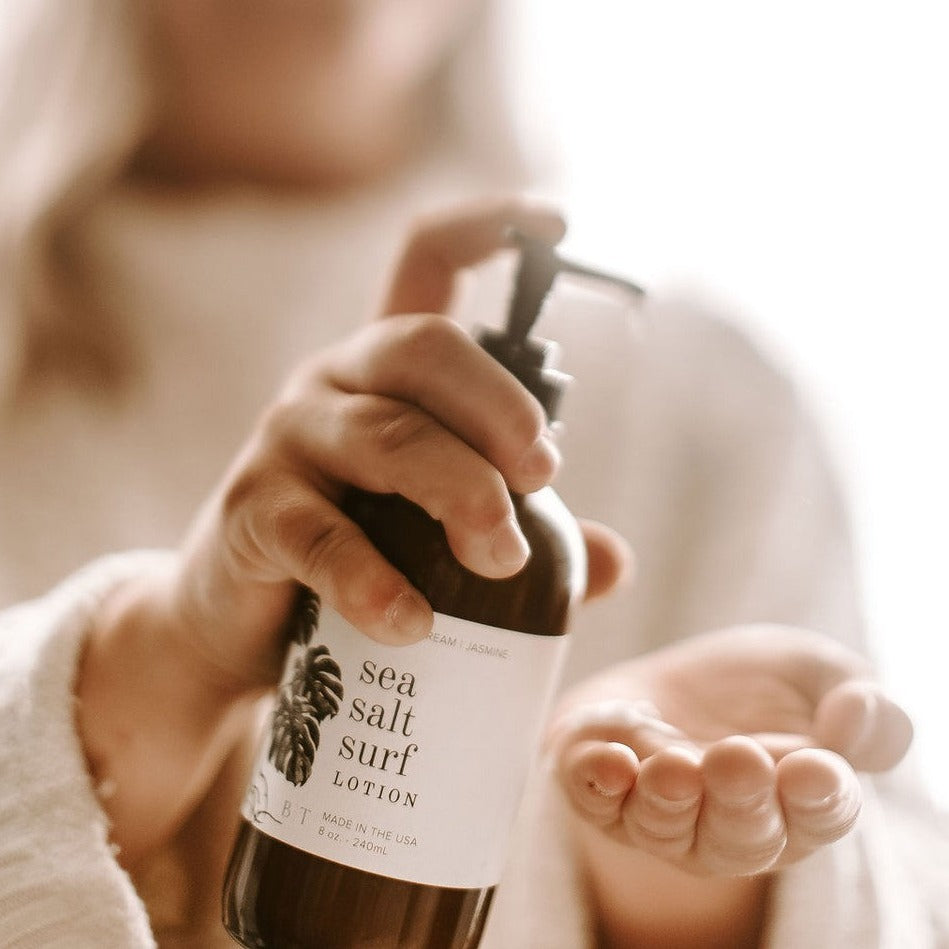 Sea Salt Surf Lotion being held and dispensed into women's hand