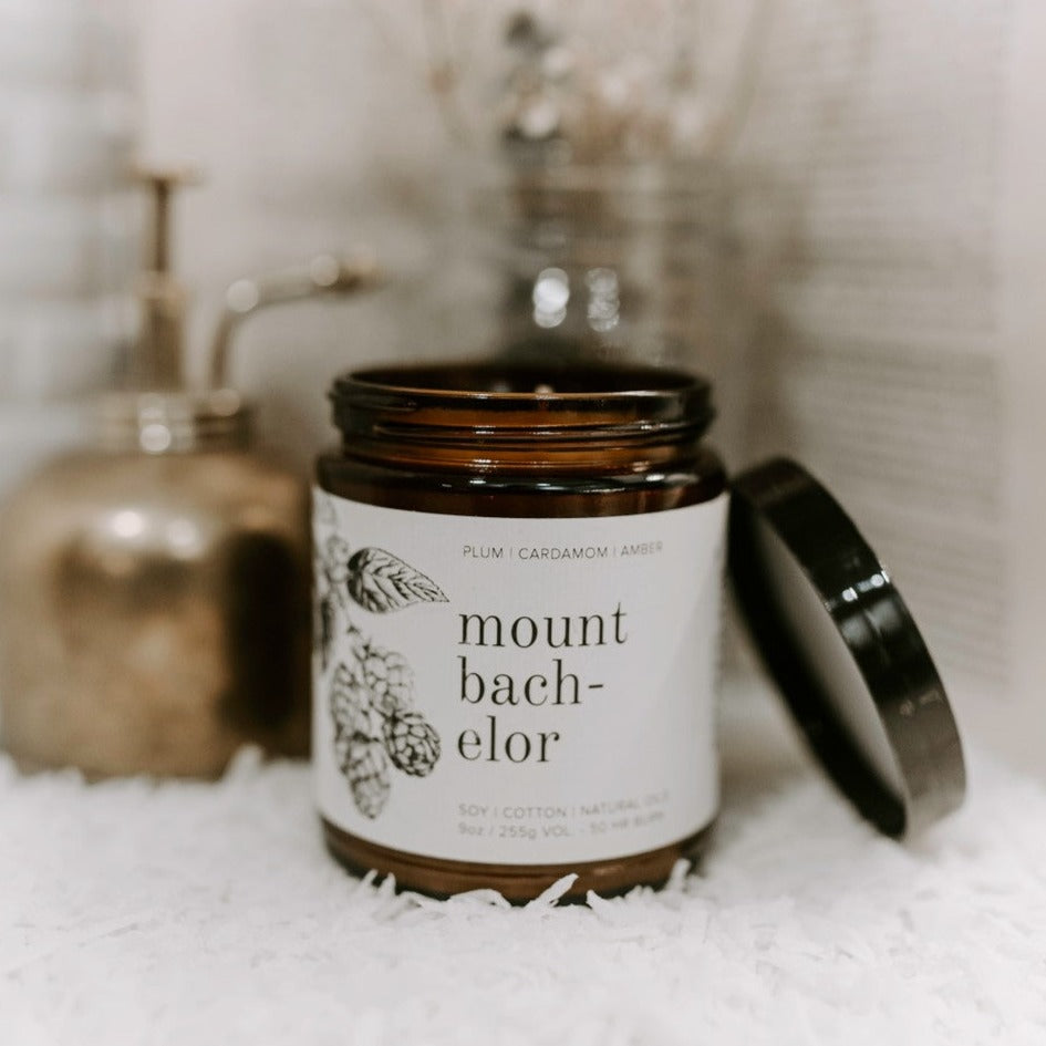 9oz Mount Bachelor candle on white cloth and sprayer