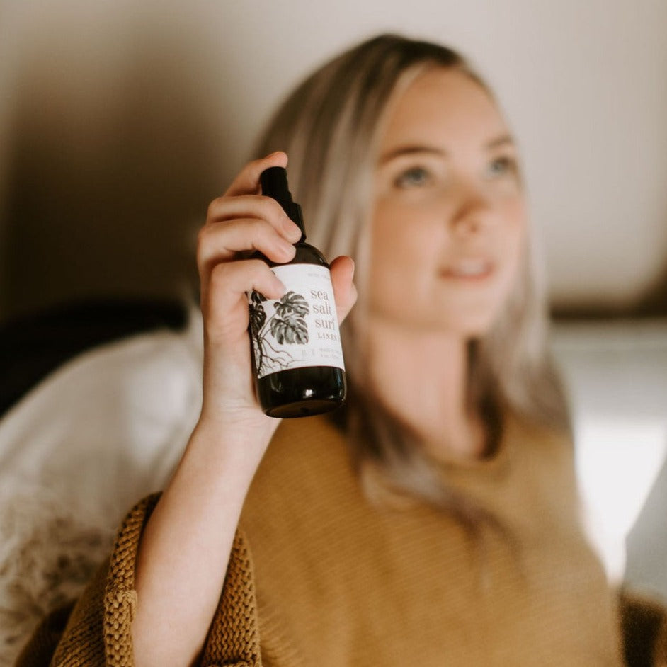4oz Sea Salt Surf spray being held by women in brown