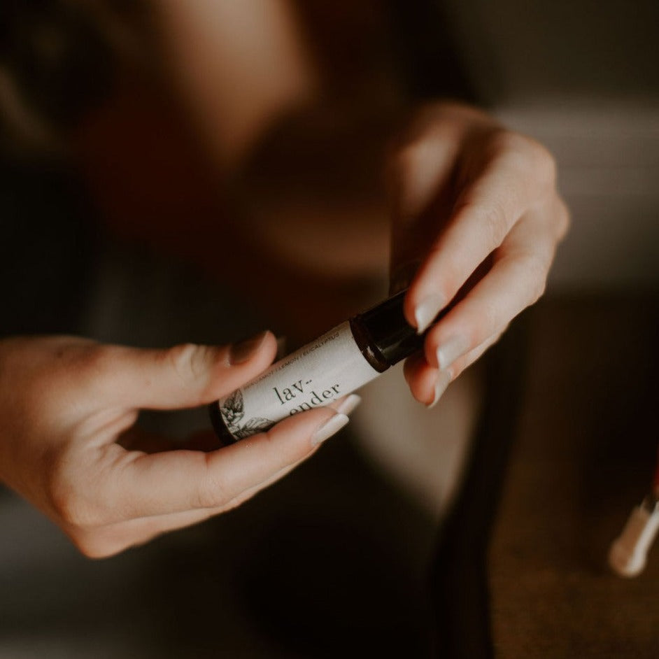 Lavender Mint roll-on perfume being held by 2 hands