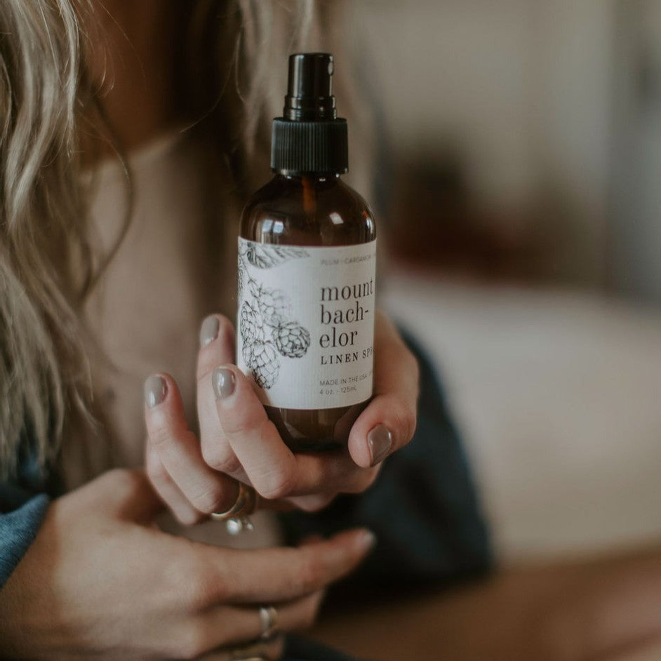 4oz Mount Bachelor linen spray held by women's hand