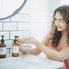 Christmas Tree 8oz lotion on sink being dispensed by women