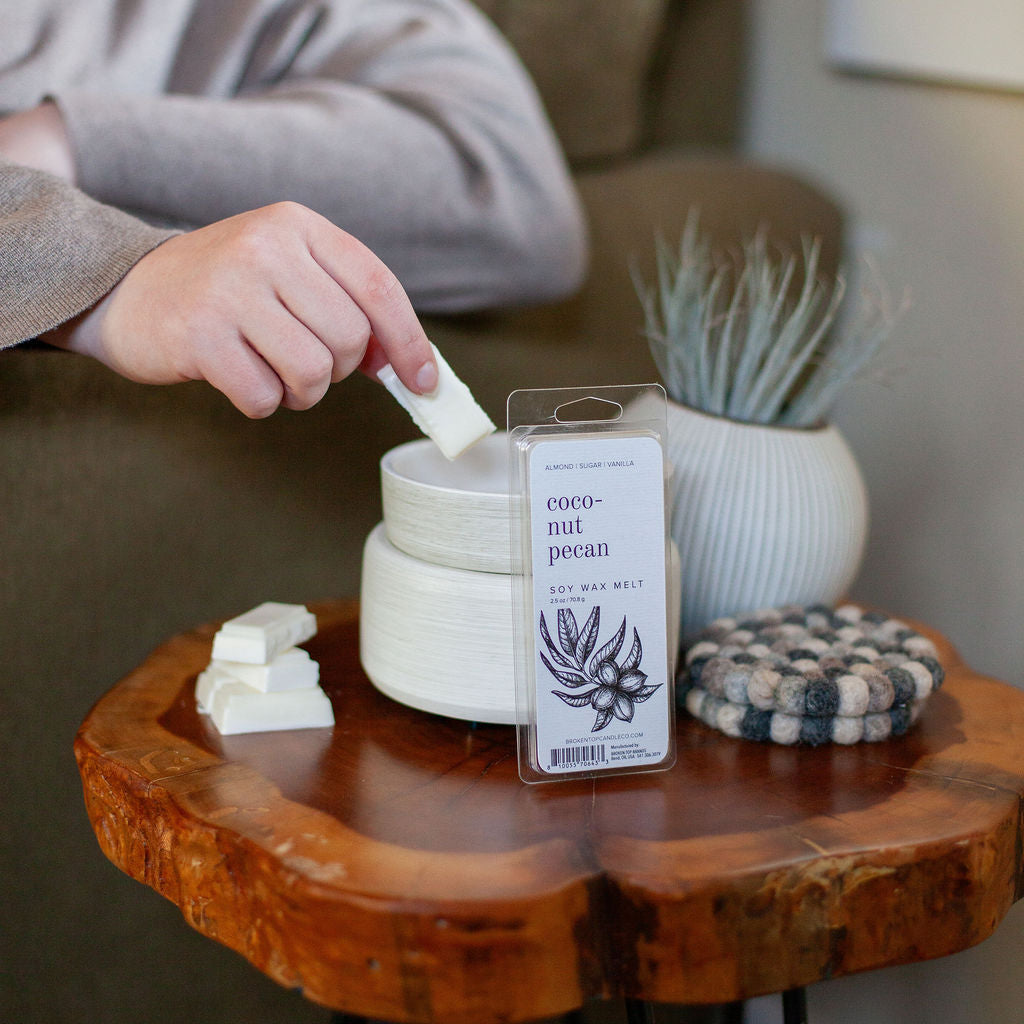 Coconut Pecan Wax Melt on a wooden side table. 