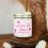 9oz 'Let's Go Girls' Soy Candle on a cowboy boot. 