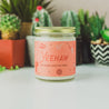 9oz 'Yeehaw' Soy Candle on a countertop with various small plants. 