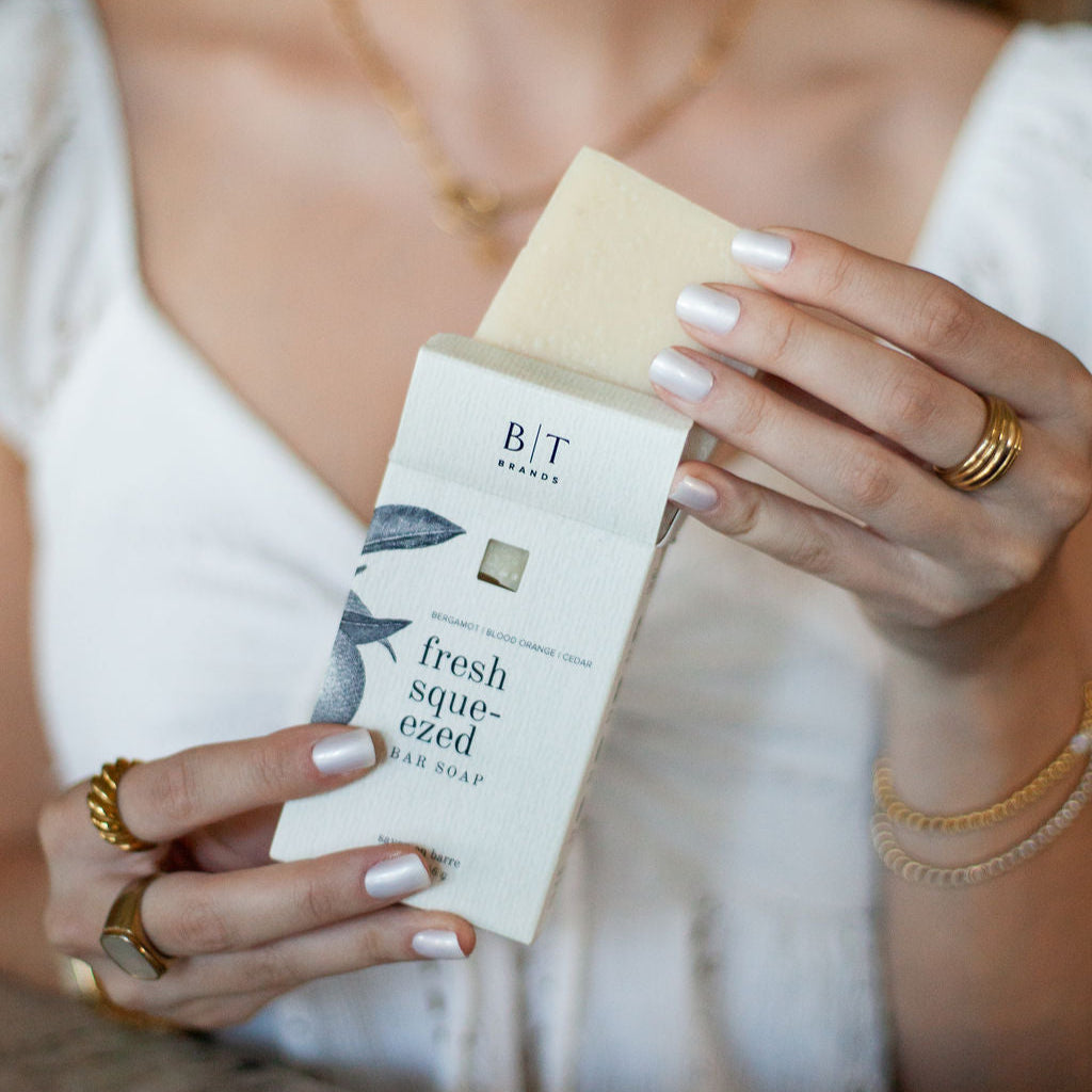 Fresh Squeezed Bar Soap being unboxed by woman's hands. 