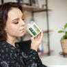 Young woman smelling 9oz 'Daydreamer' Soy Candle