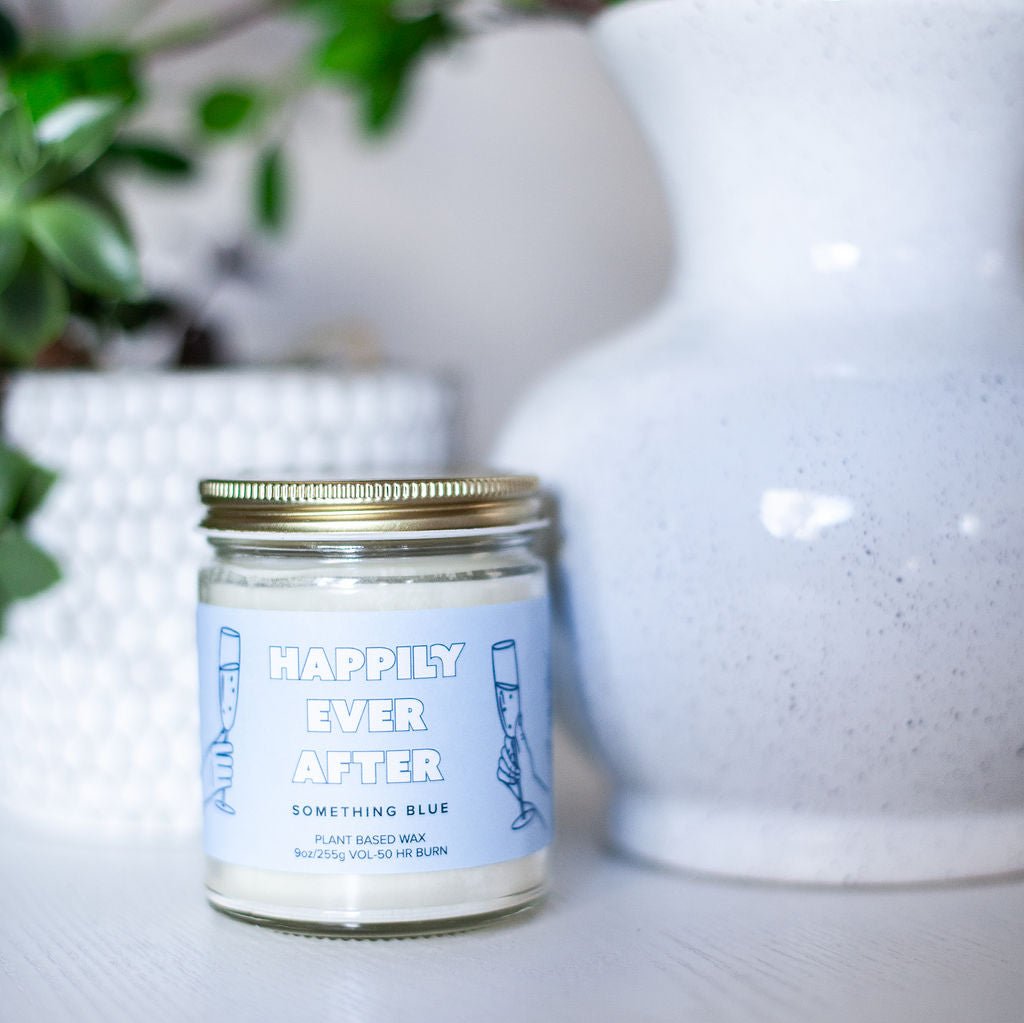 9oz 'Happily Ever After' Soy Candle on white table next to tall vase