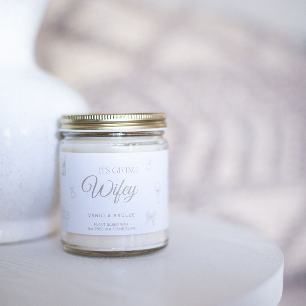 9oz 'Its Giving Wifey' Soy Candle next to white vase on white table