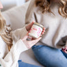 Woman holding 9oz 'In My Mom Era' Soy Candle while sitting next to young woman