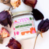 9oz 'Ain't No Hood Like Motherhood' Soy Candle laying down surrounded by dried roses