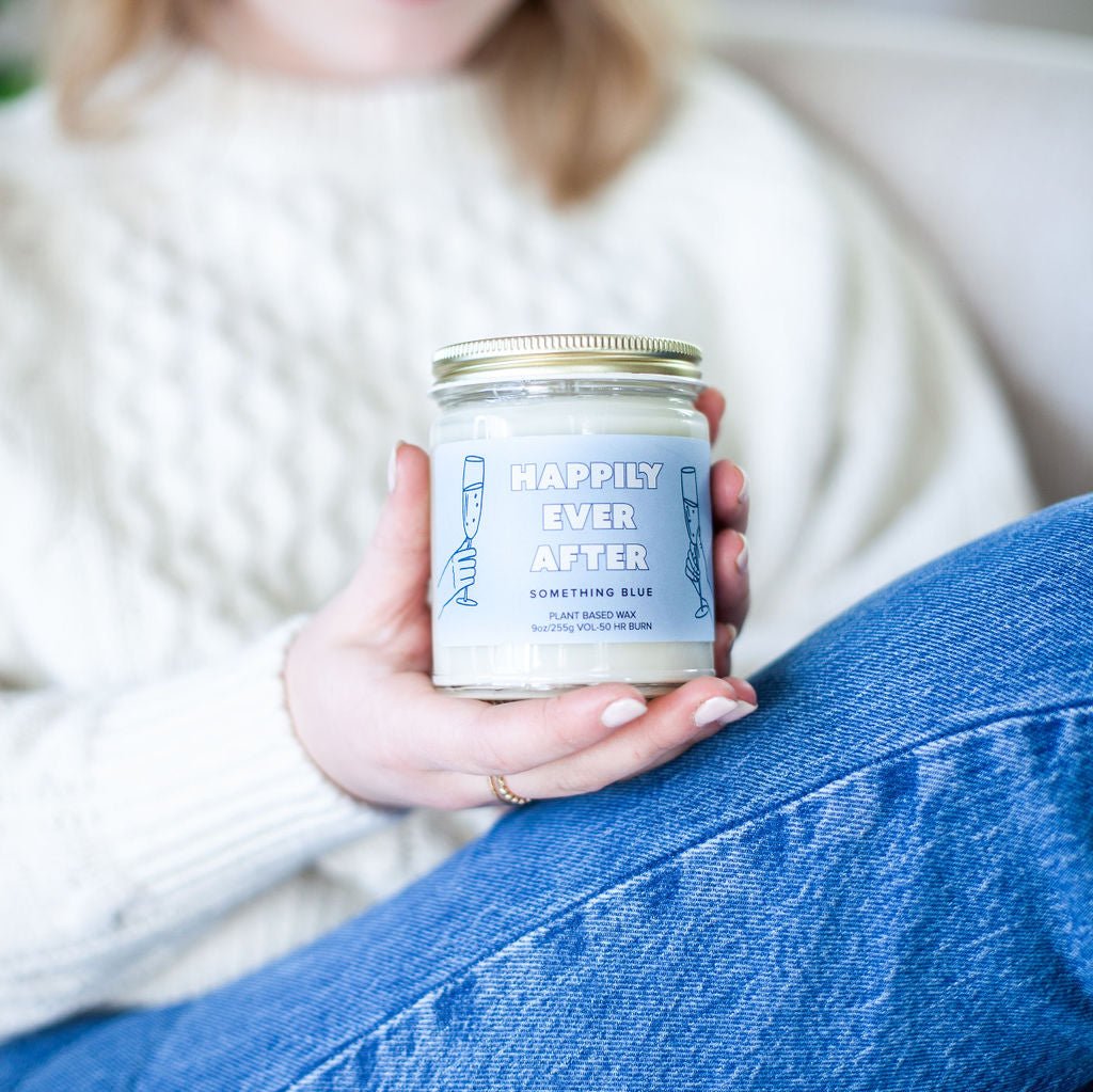 Woman holding 9oz 'Happily Ever After' Soy Candle while sitting