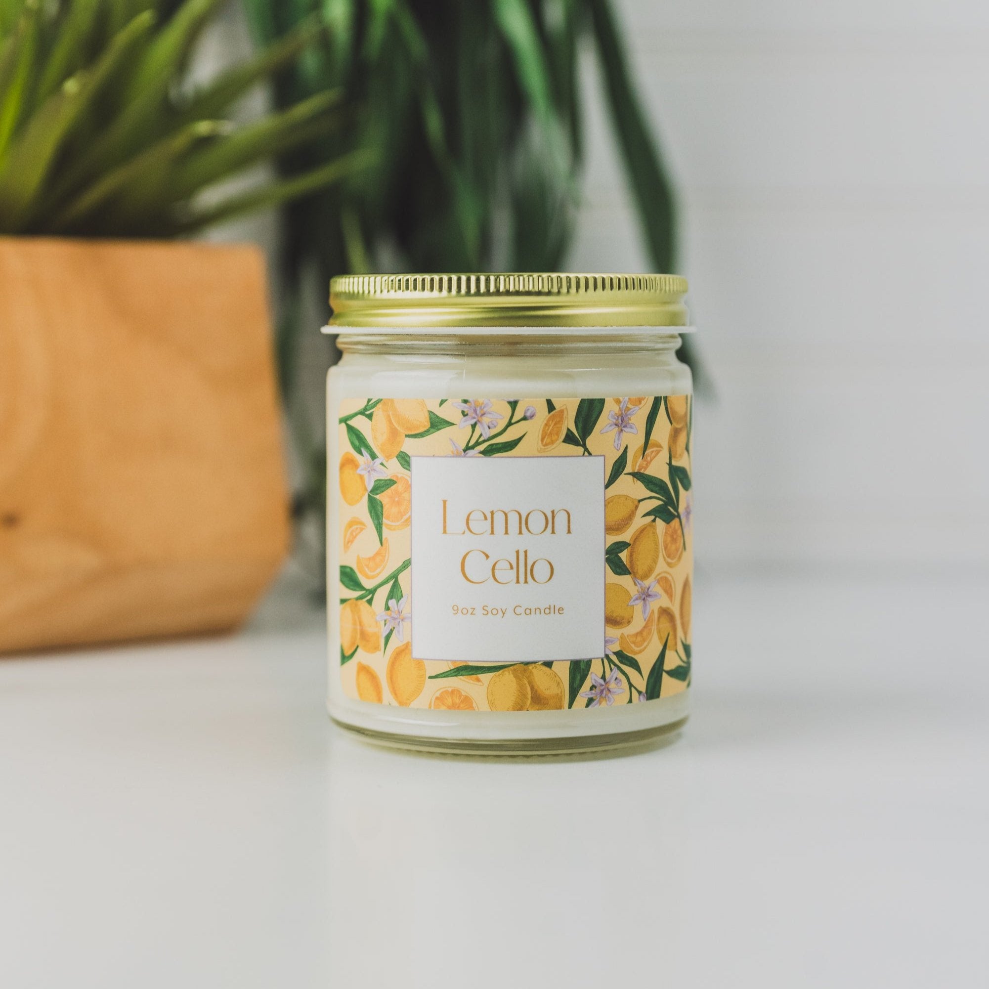 9oz 'Lemon Cello' Soy Candle on white table with plants in background