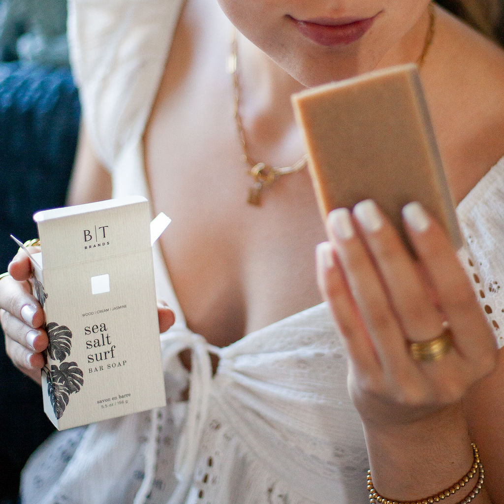 Sea Salt Surf Bar Soap being unboxed by a woman. 