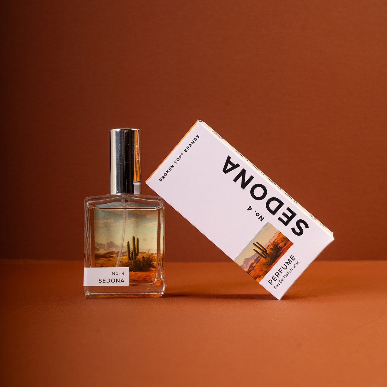 Perfume bottle and packaging with 'SEDONA' branding on an orange background